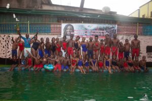 A group photo of swimmers, coaches, and volunteers that participated in No Limit International's swimming camp in July 2022.