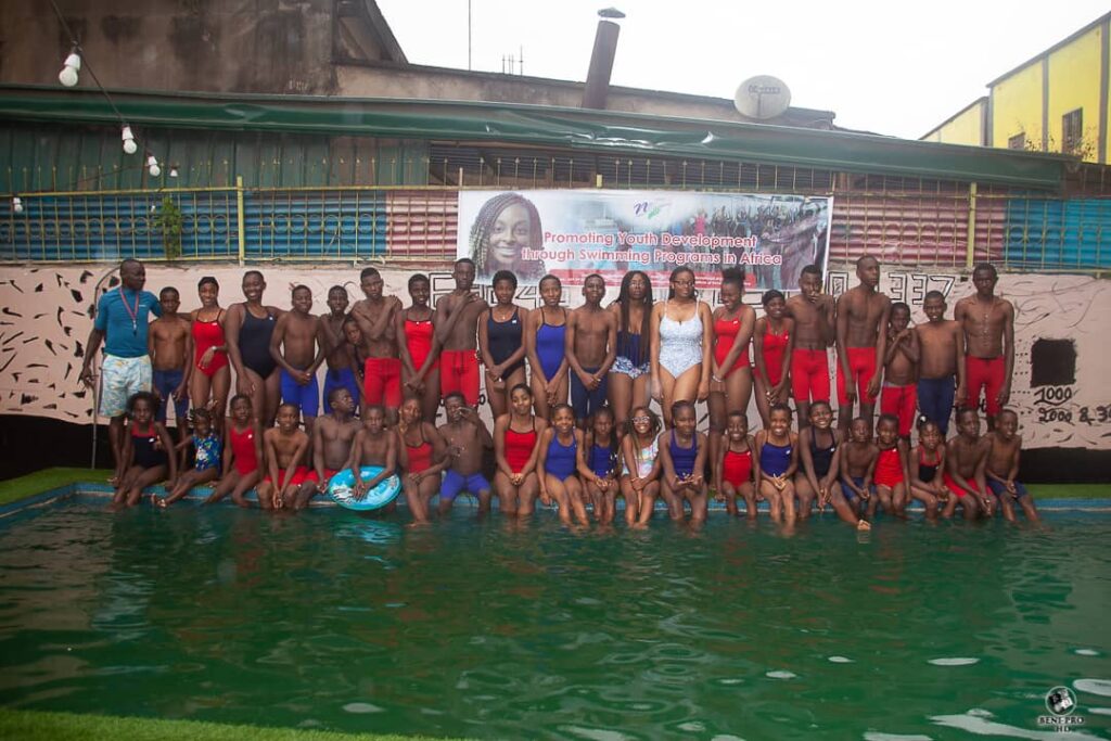 A group photo of swimmers, coaches, and volunteers that participated in No Limit International's swimming camp in July 2022.