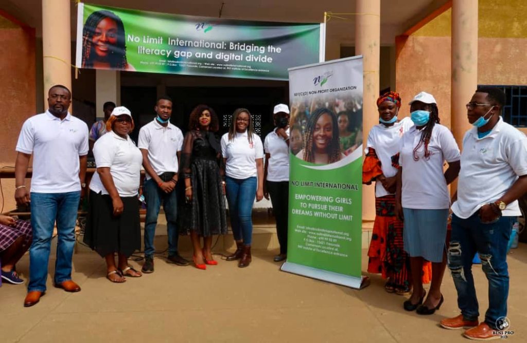 A team of No Limit International volunteers under the leadership of No Limit International Co-Founder Orlyanka Tantchou poses with officials from a primary school in Cameroon.