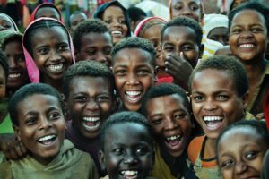 A group of African children smiling at the camera.