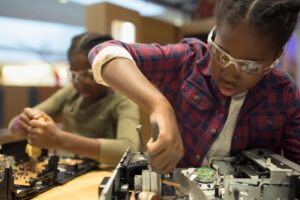 Two girls working on a coding science project.